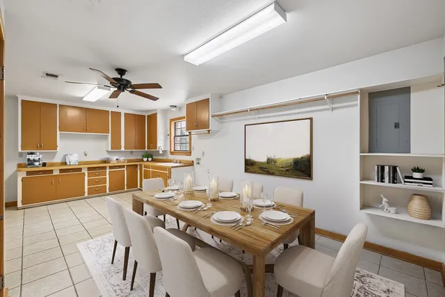 a kitchen with a table chairs stove and kitchen view