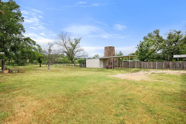 a view of a swimming pool with a yard