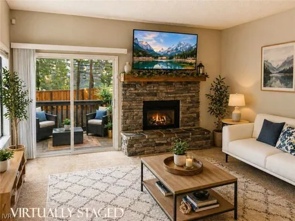 a living room with furniture a rug a window and a fireplace