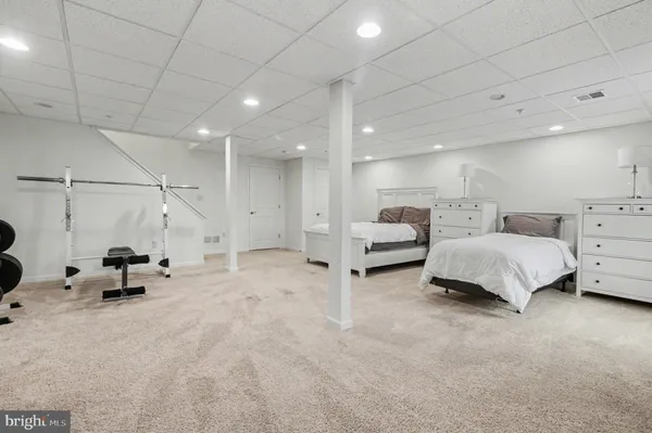 a spacious bedroom with a bed a table and chairs