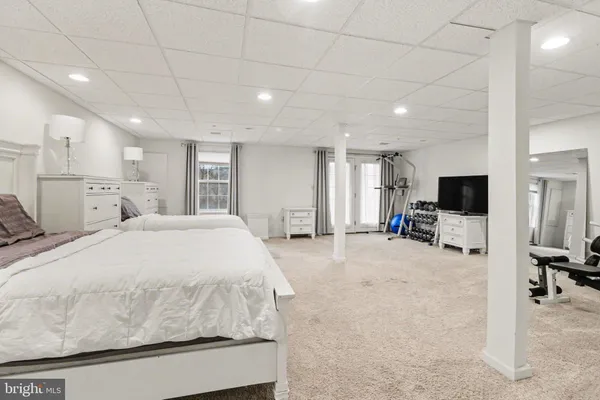 a spacious bedroom with a bed and a flat screen tv