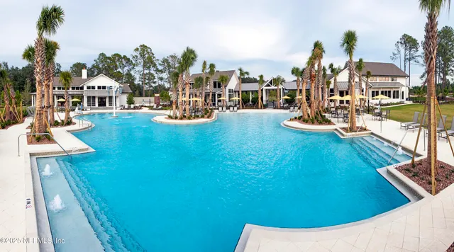 a front view of a house with a yard and trees