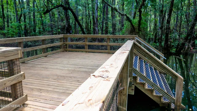 a large bed sitting in a bedroom next to a window