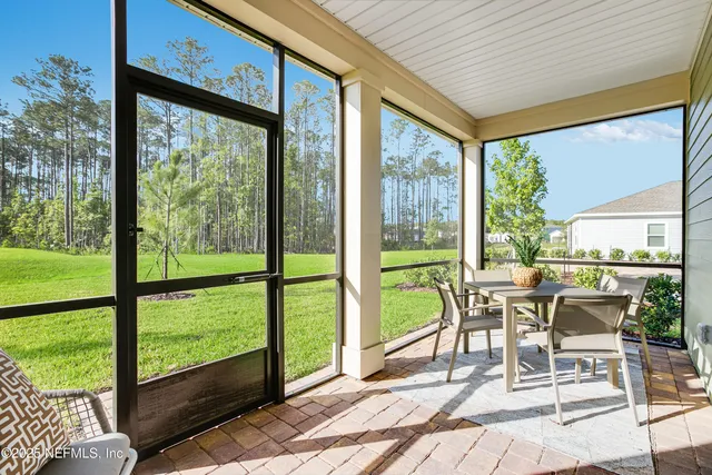 a bedroom with a bed lamp and paintings on the wall