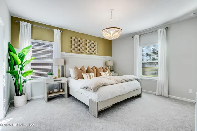 a bedroom with a bed and a chandelier