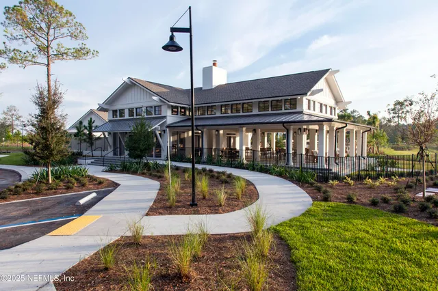 a view of a house with swimming pool and sitting area