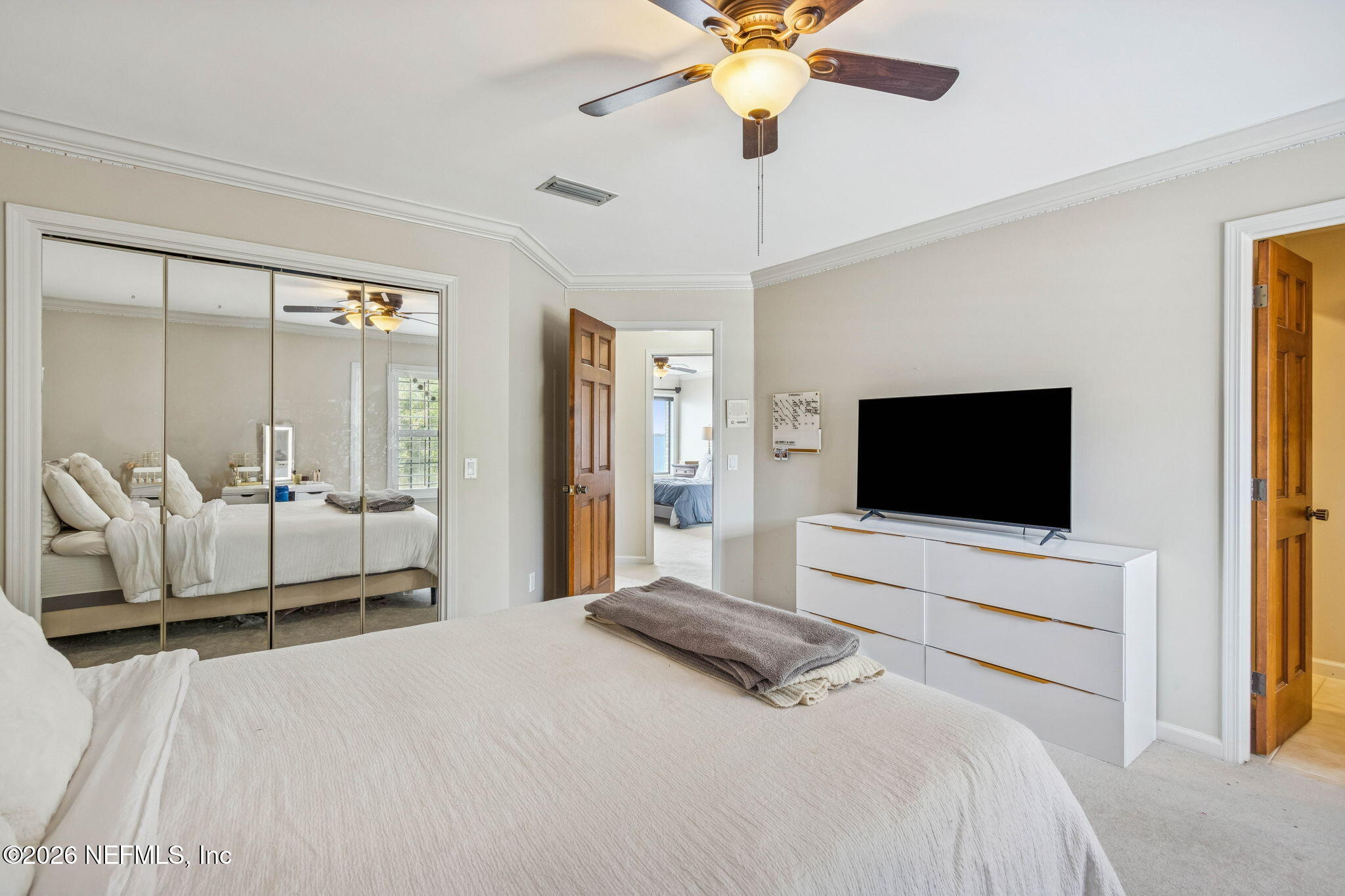 6518 Christopher Point Road West Jacksonville, FL 32217 - Photo 70 of 102 a bedroom with a bed and a flat screen television