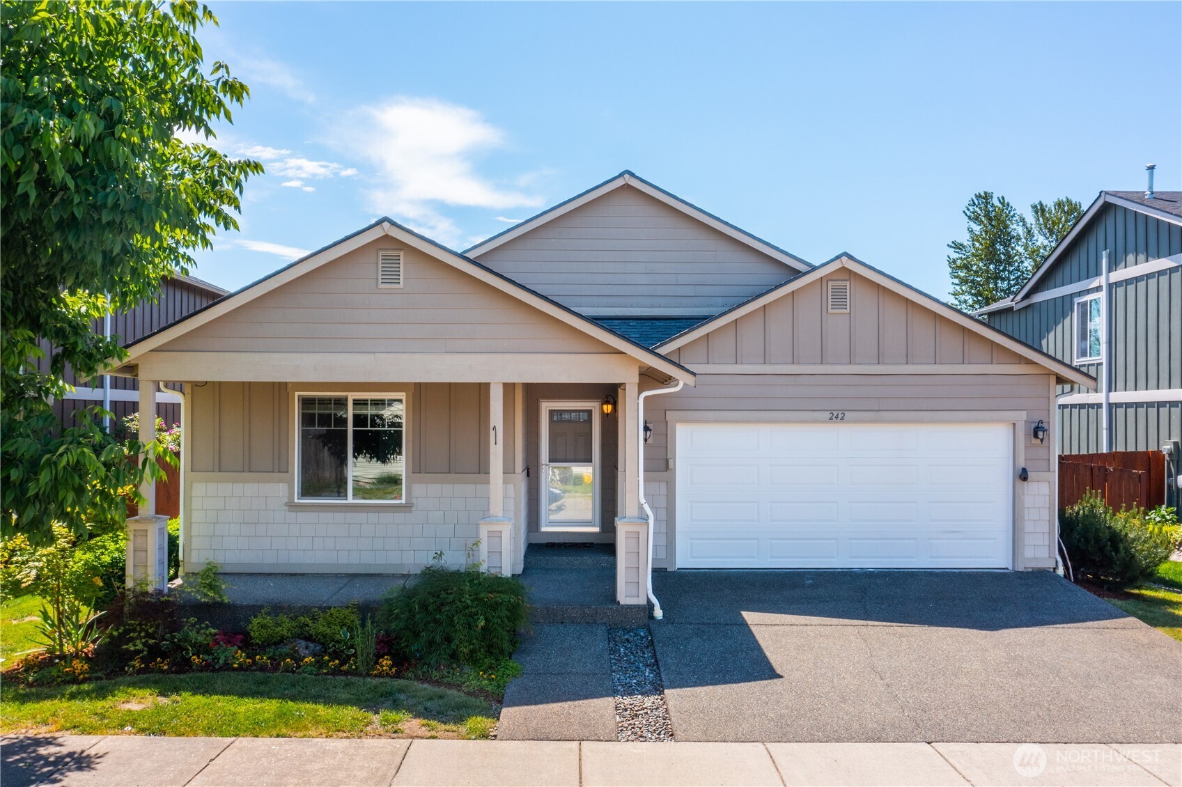 242 Riggs Drive East Enumclaw, WA 98022 - Photo 1 of 40 a front view of a house with garden