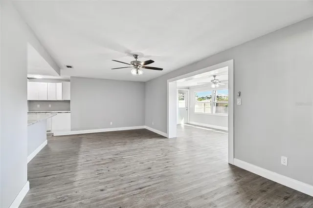 a bathroom with a granite countertop sink a toilet and a mirror