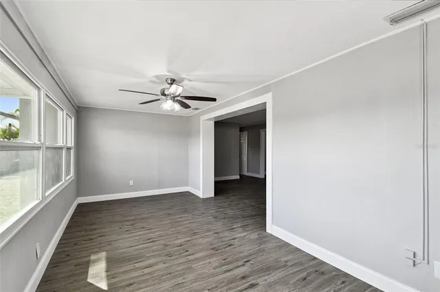 wooden floor in an empty room with a window