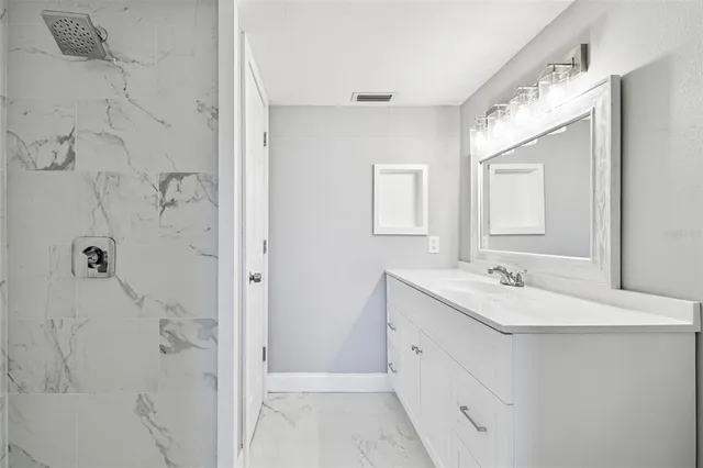 an empty room with wooden floor ceiling fan and window