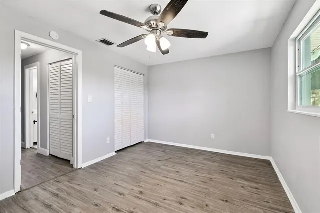an aerial view of residential houses with outdoor space and trees