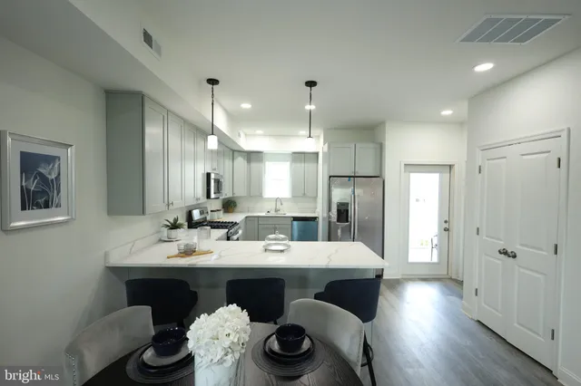 a large kitchen with a table and chairs