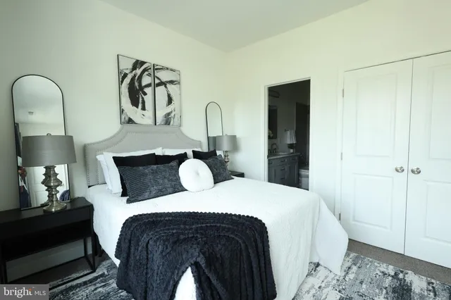 a bedroom with a bed and a mirror