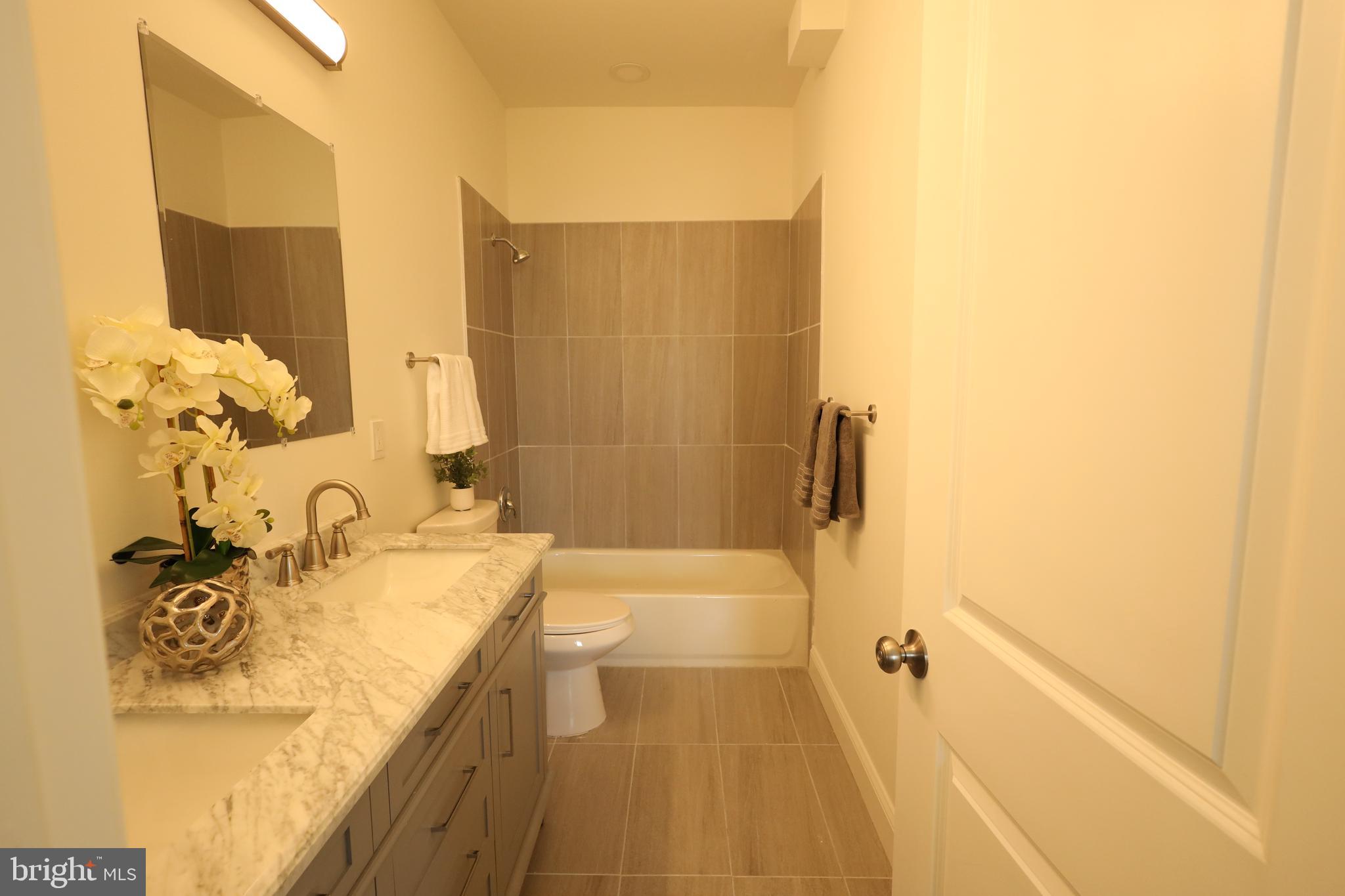3316 North Market Street Wilmington, DE 19802 - Photo 23 of 40 a bathroom with a granite countertop sink and a mirror