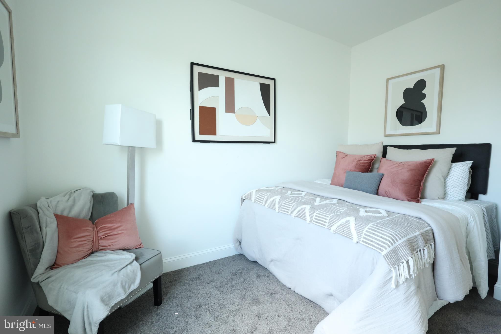 3316 North Market Street Wilmington, DE 19802 - Photo 26 of 40 a spacious bedroom with a bed and a lamp