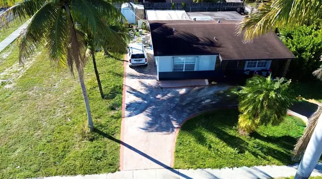 a aerial view of a house with a yard