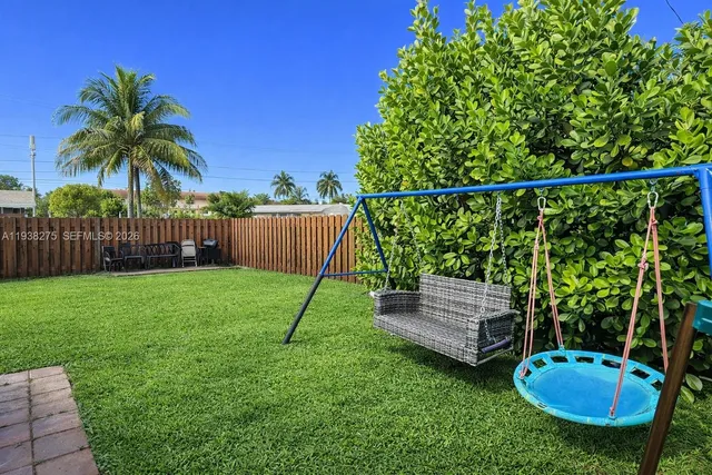 a view of a chair and table in the garden