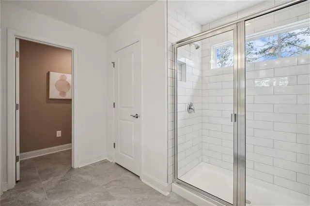 a bathroom with a shower and a glass door