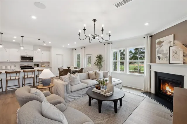 a living room with furniture kitchen view and a fireplace