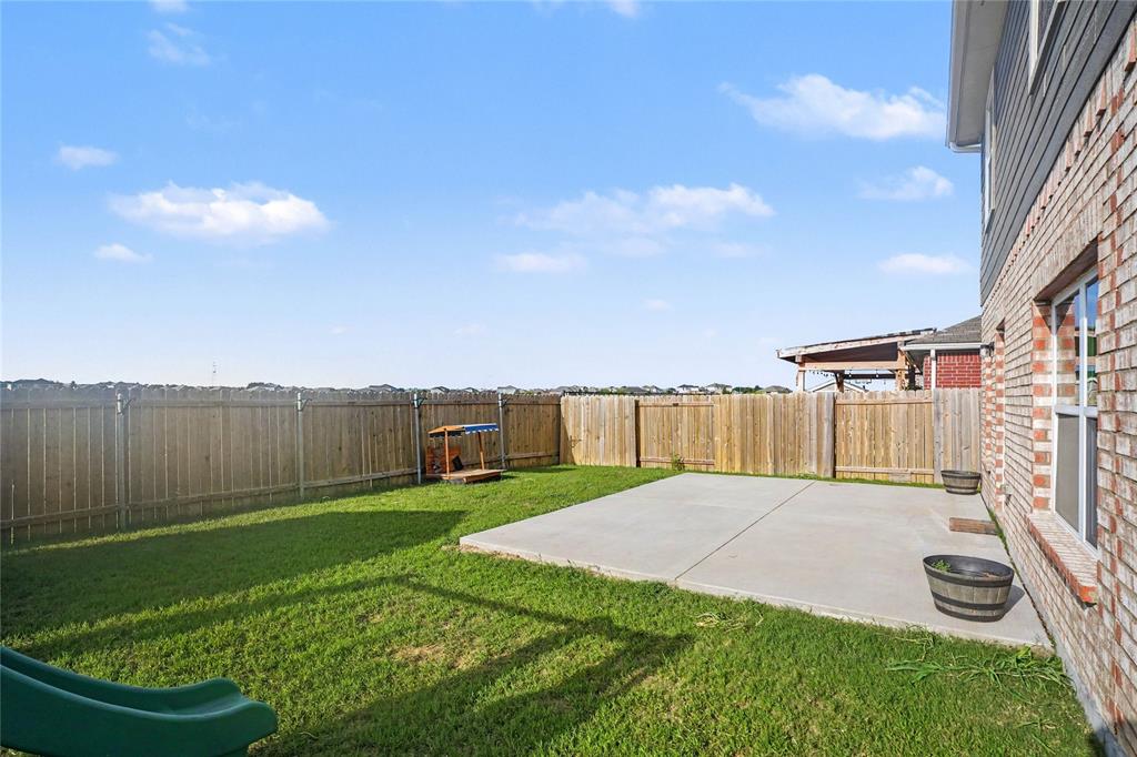 125 Sammy Venus, TX 76084 - Photo 32 of 39 Expansive backyard featuring a concrete patio, a manicured lawn, and a wood privacy fence