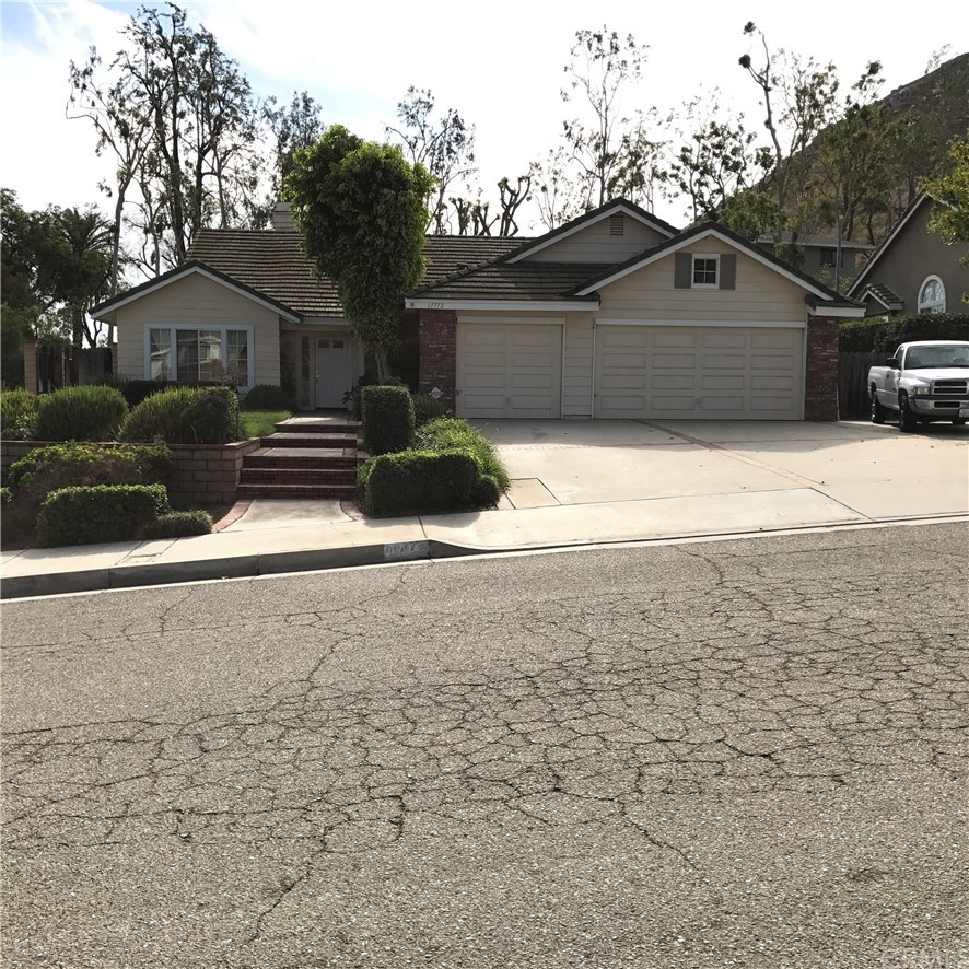11772 Tilden Place Riverside, CA 92505 - Photo 1 of 1 a front view of a house with a yard and garage