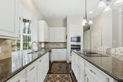 108 Inverness Conroe, TX 77356 - Photo 13 of 29 a large kitchen with stainless steel appliances granite countertop a lot of counter space and a sink