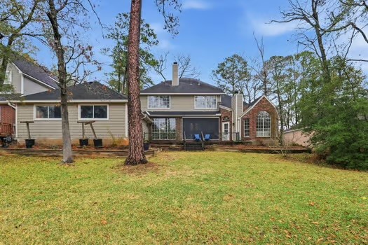 108 Inverness Conroe, TX 77356 - Photo 29 of 29 a house view with a swimming pool and wooden fence