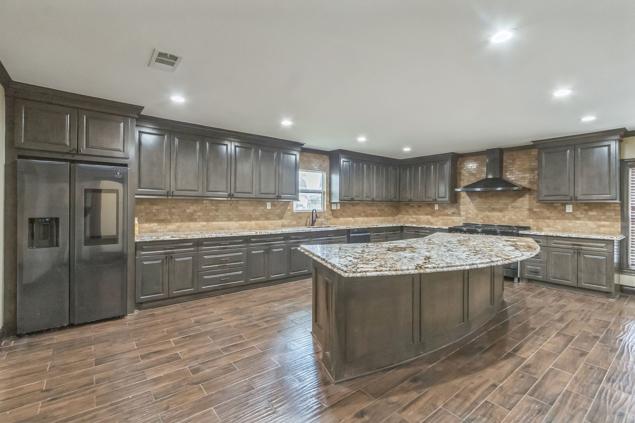 24578 Derry Street Hempstead, TX 77445 - Photo 13 of 50 The island is perfect for hosting and extra seating for people to gather while you cook!