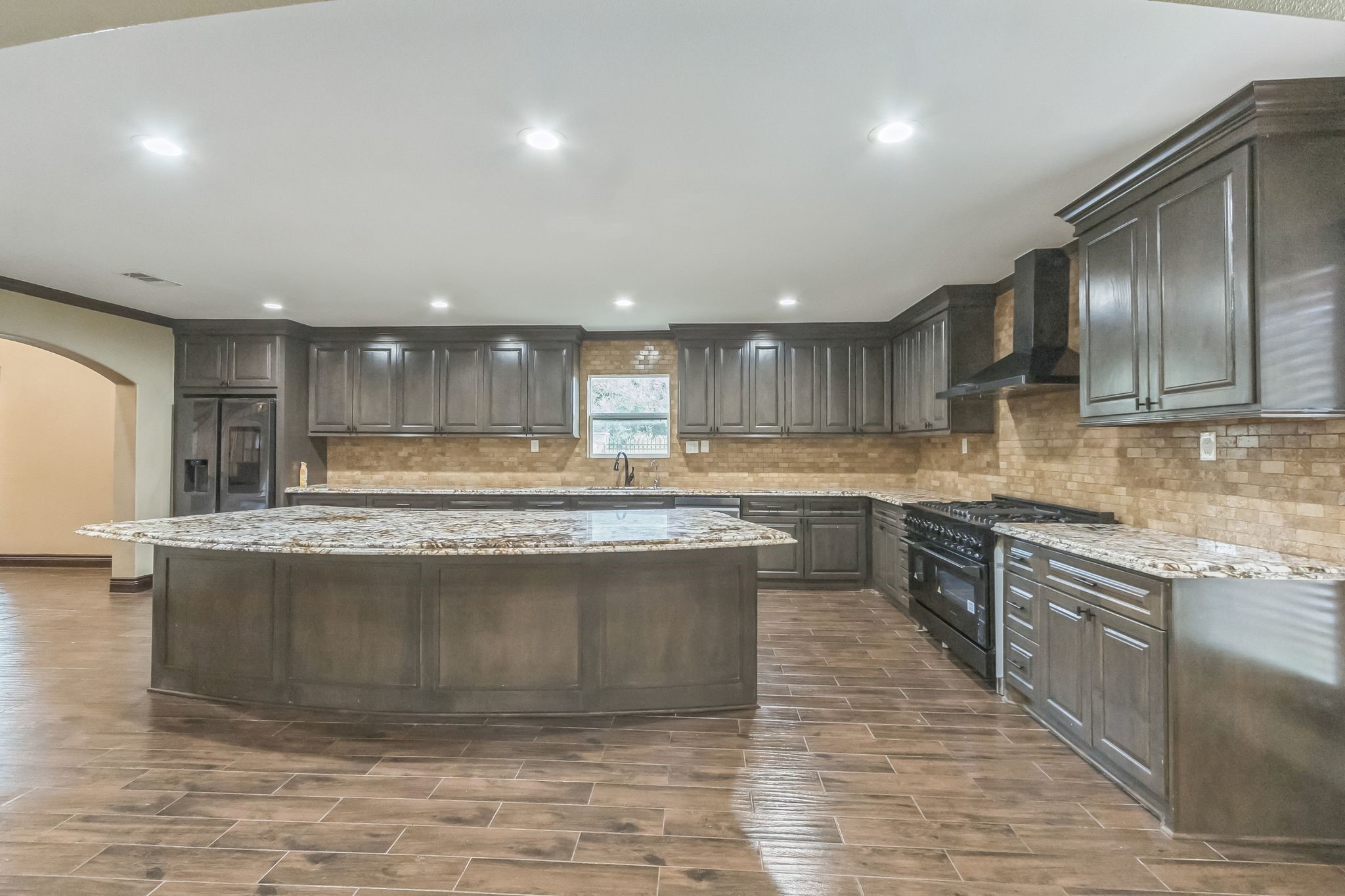 24578 Derry Street Hempstead, TX 77445 - Photo 15 of 50 So many details to love in the heart of the home. This kitchen boasts a large cooktop as well as plenty of counter and cabinet space.