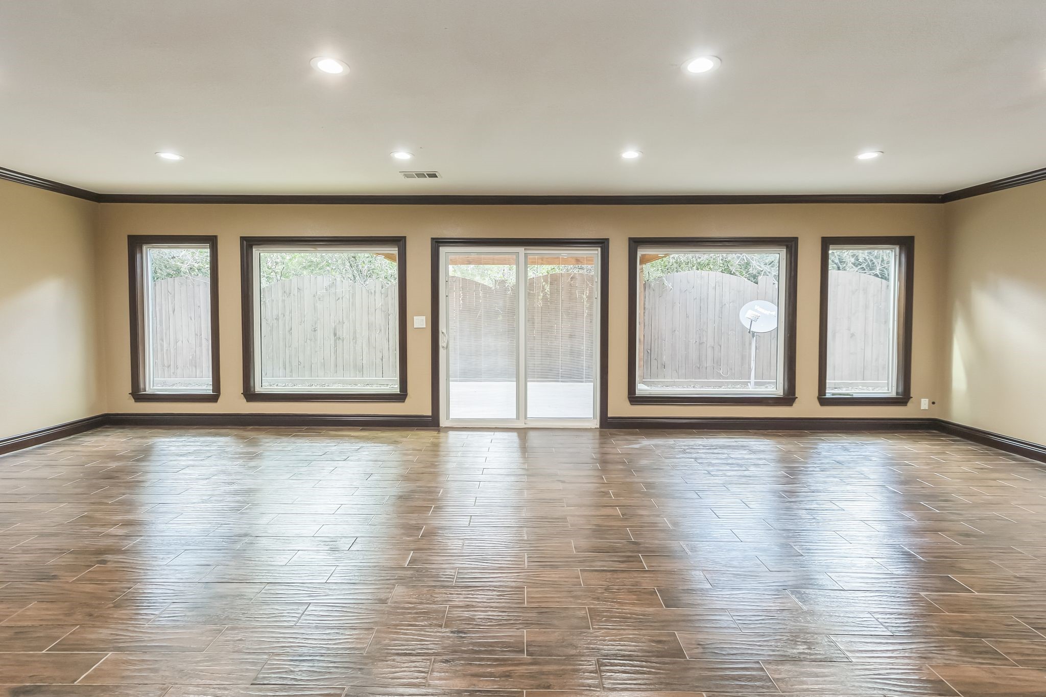 24578 Derry Street Hempstead, TX 77445 - Photo 9 of 50 Ample natural light from large windows and a sliding glass door leading to the backyard. Recessed lighting and neutral walls create a warm, inviting atmosphere.