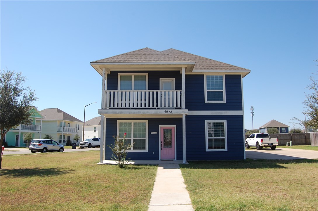 6942 Halter Loop College Station, TX 77845 - Photo 1 of 28 Traditional-style house featuring a front yard, covered porch, roof with shingles, and a balcony