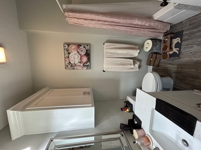 6942 Halter Loop College Station, TX 77845 - Photo 16 of 28 Bathroom featuring dark wood-style flooring, shower / bath combo, and vanity