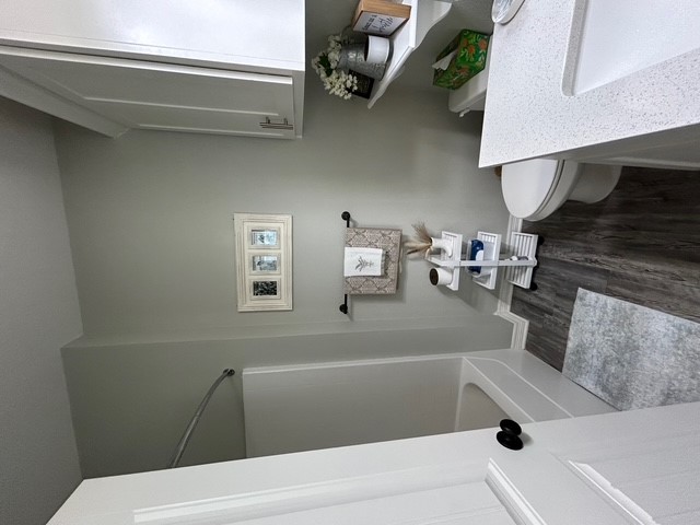 6942 Halter Loop College Station, TX 77845 - Photo 19 of 28 Full bath with dark wood finished floors, tub / shower combination, and vanity