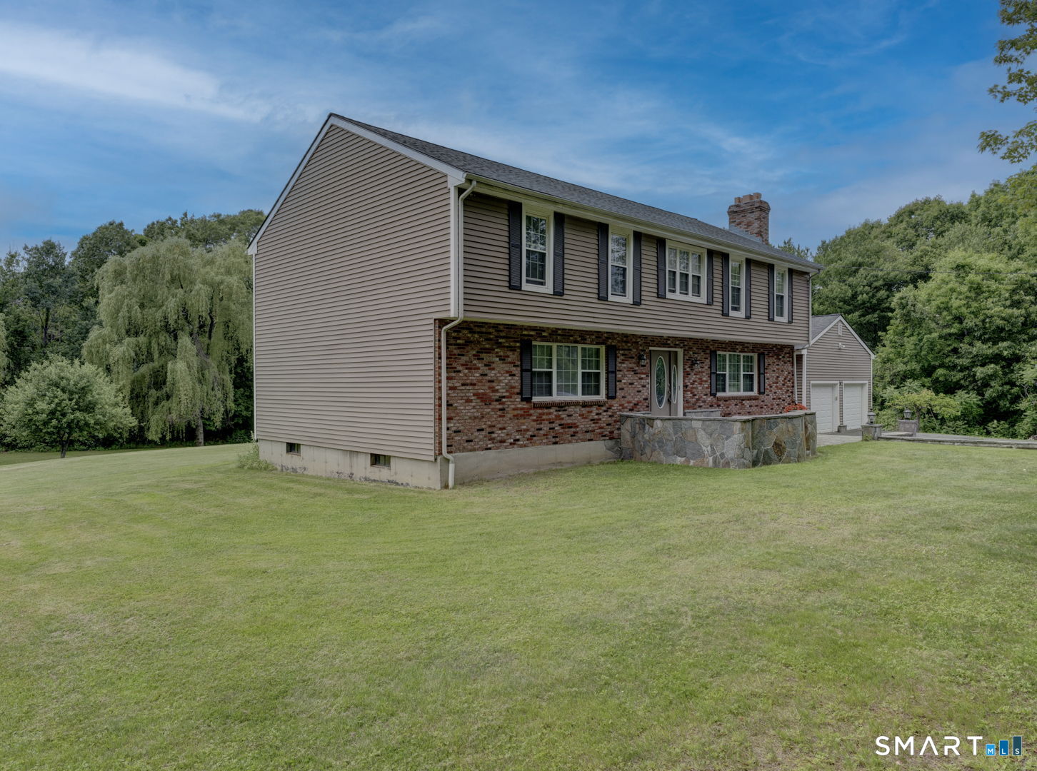Exterior left side of home , brick and vinyl siding , vinyl clad windows