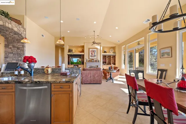 a dining room with furniture a chandelier and wooden floor