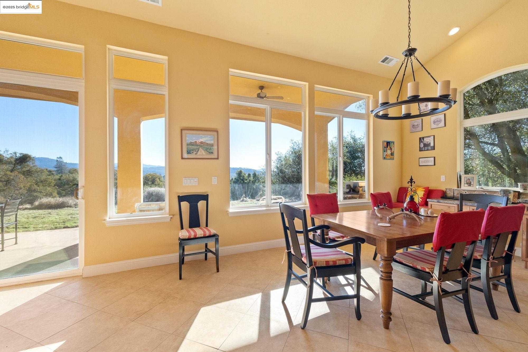 21190 Lyons Bald Mountain Road Sonora, CA 95370 - Photo 12 of 49 a dining room with furniture a chandelier and wooden floor