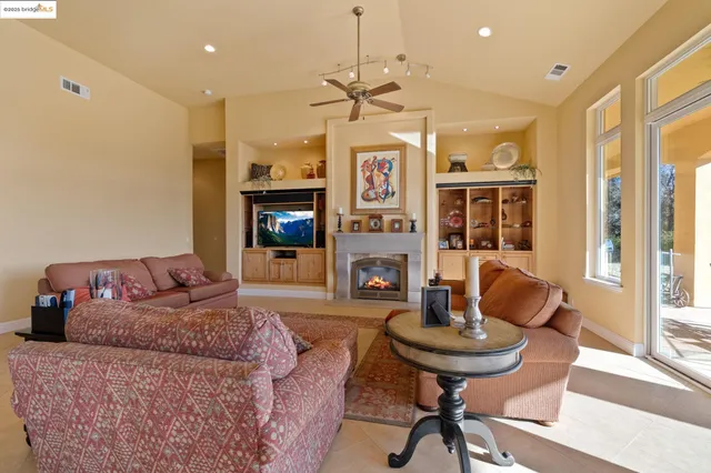 a living room with fireplace furniture and a flat screen tv
