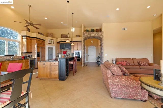 a bedroom with furniture and a large window