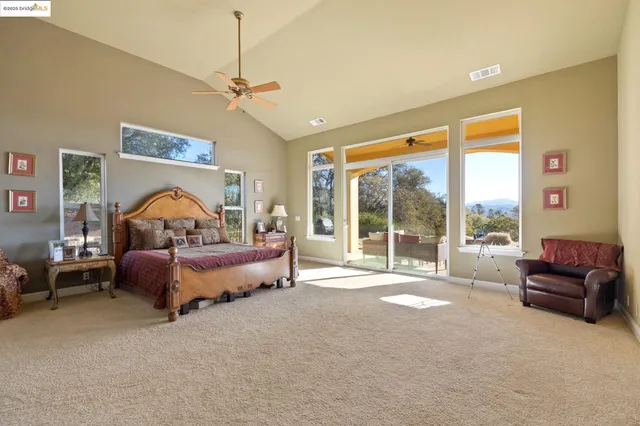 a bedroom with bed and a large window