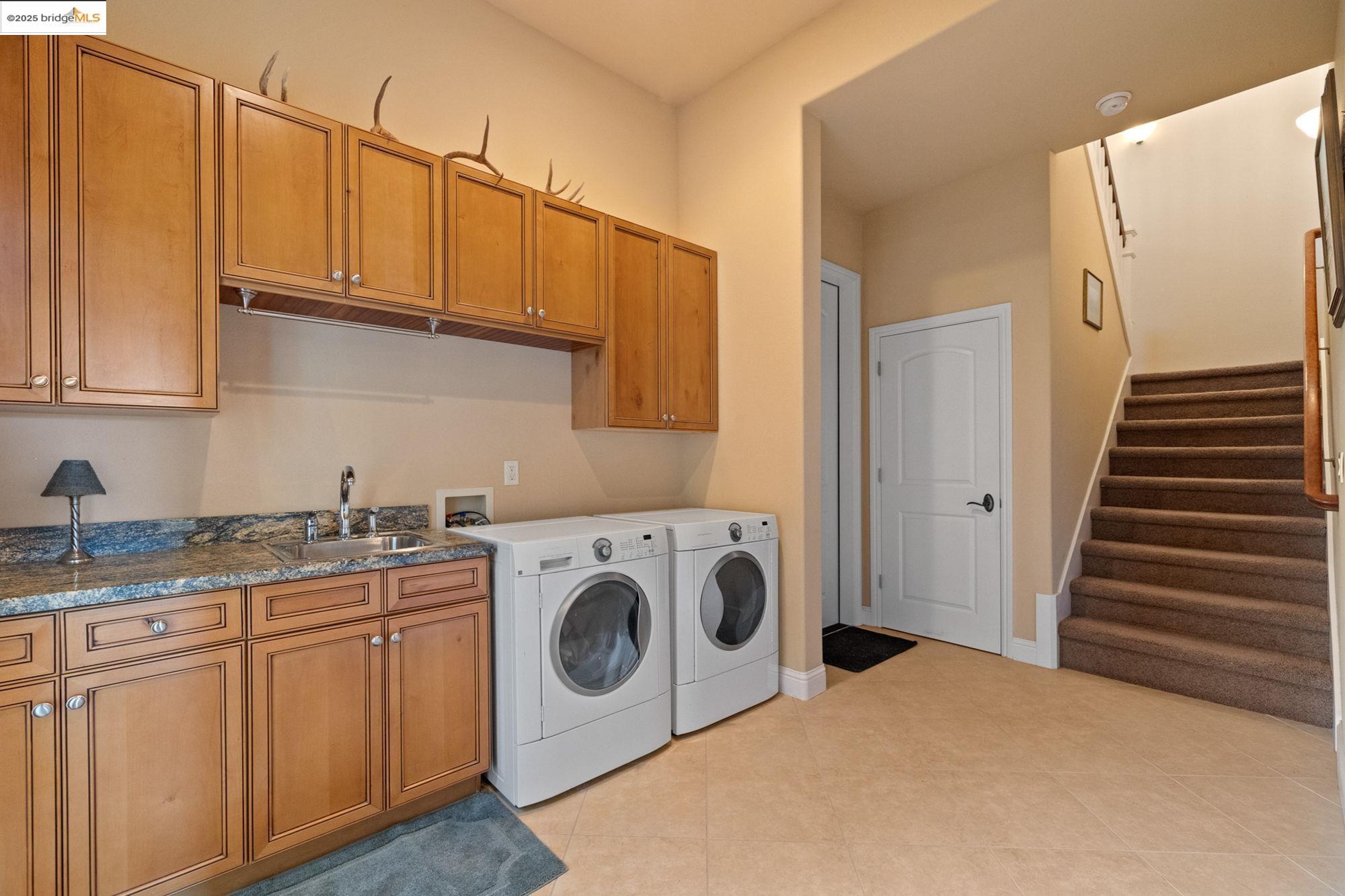 21190 Lyons Bald Mountain Road Sonora, CA 95370 - Photo 30 of 49 a utility room with sink dryer and washer