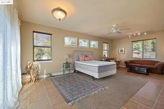 a spacious bedroom with a bed and a table in it