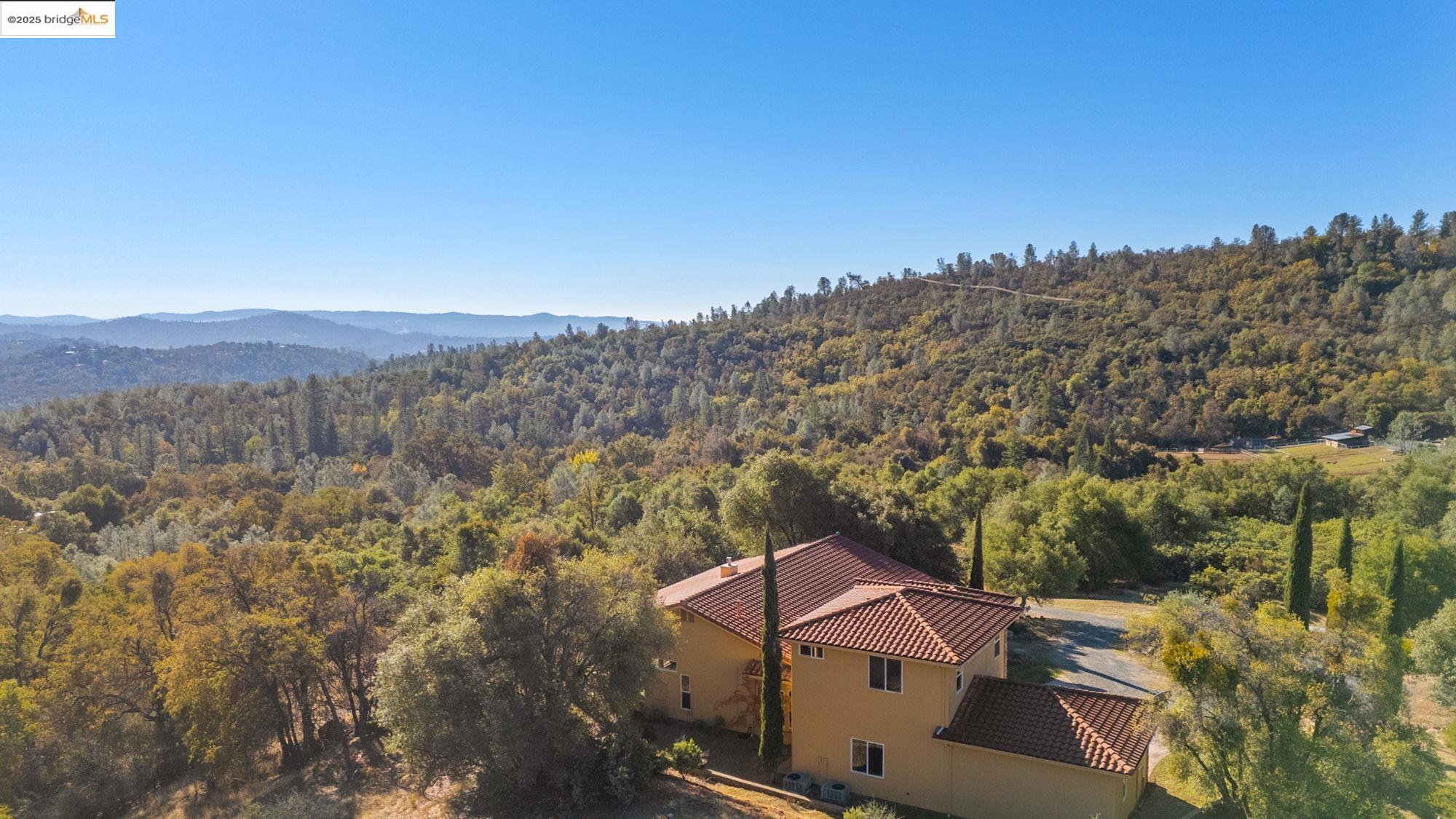 21190 Lyons Bald Mountain Road Sonora, CA 95370 - Photo 41 of 49 a view of a house with a mountain in the background