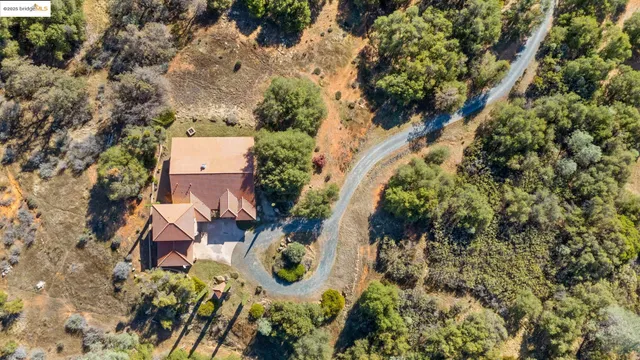 a view of a lush green field with mountains in the background