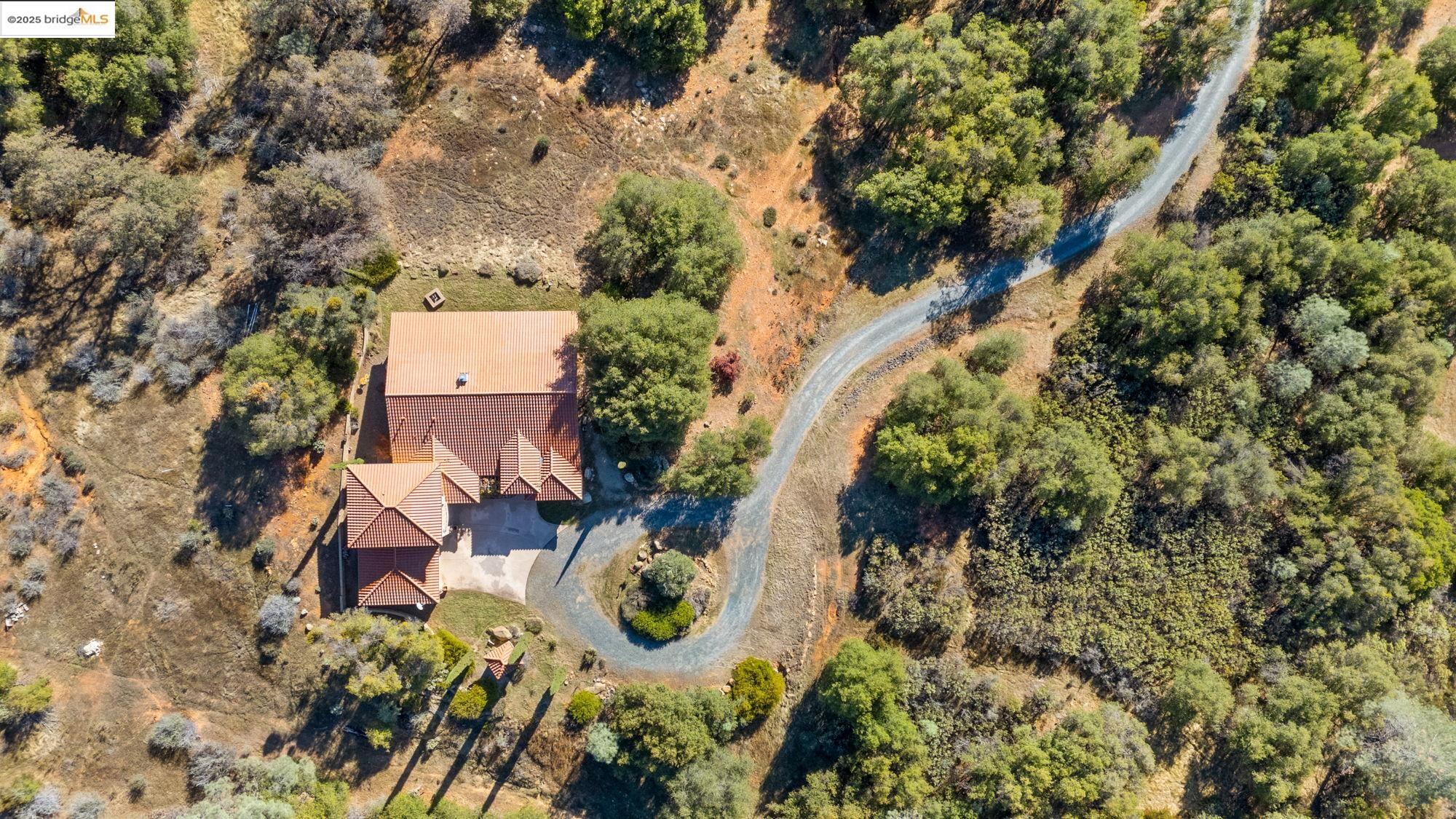 21190 Lyons Bald Mountain Road Sonora, CA 95370 - Photo 47 of 49 an aerial view of a house with a yard and lake view