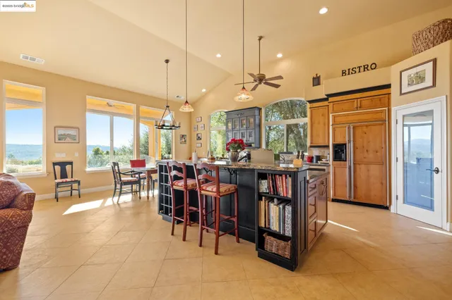 a kitchen with stainless steel appliances granite countertop a refrigerator and a stove