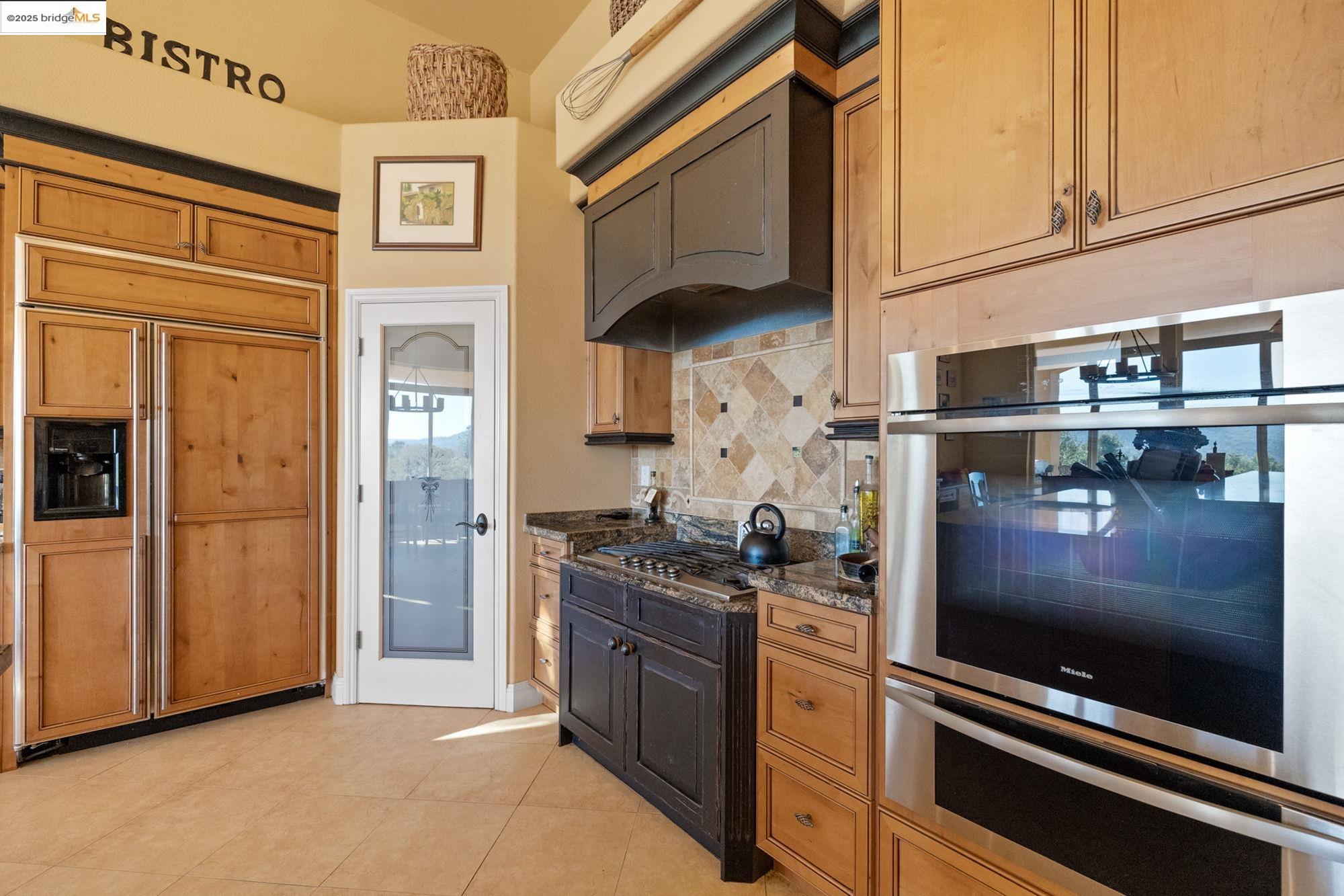 21190 Lyons Bald Mountain Road Sonora, CA 95370 - Photo 8 of 49 a kitchen with stainless steel appliances granite countertop a refrigerator and a stove