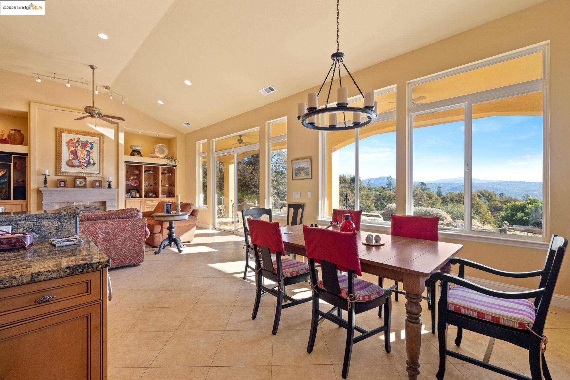 21190 Lyons Bald Mountain Road Sonora, CA 95370 - Photo 9 of 49 a dining room with furniture a chandelier and a rug