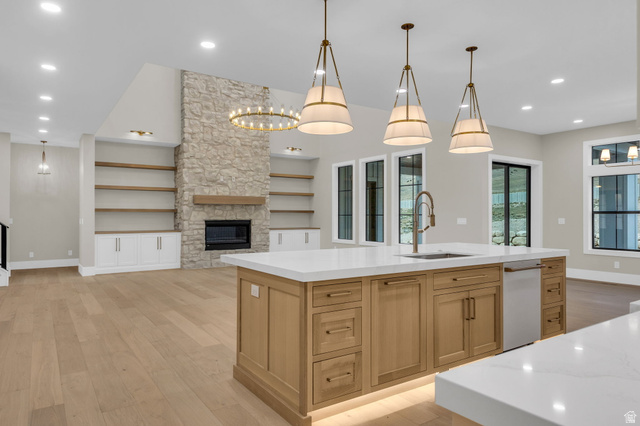 2828 Jojo Road Eagle Mountain, UT 84005 - Photo 16 of 63 Gourmet kitchen island with white countertops, integrated sink, and undermount lighting