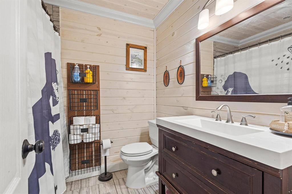 625 County Road Paris, TX 75462 - Photo 12 of 31 a bathroom with a toilet sink and mirror